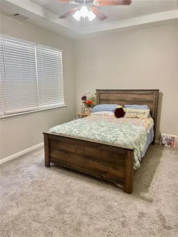 a bed sitting in a room next to a window