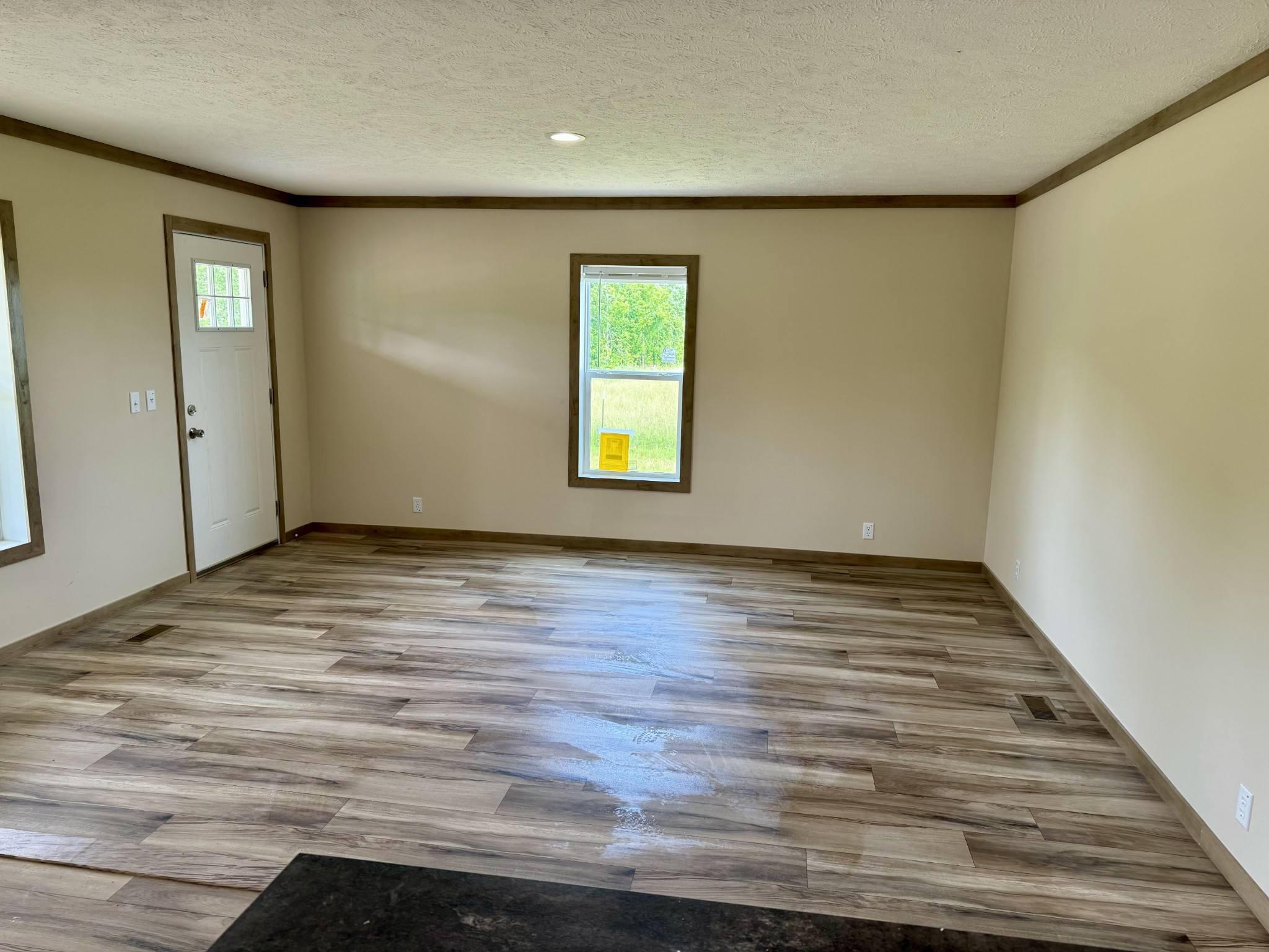 146 Driver Road Lafayette, TN 37083 - Photo 5 of 29 a view of an empty room with wooden floor and a window