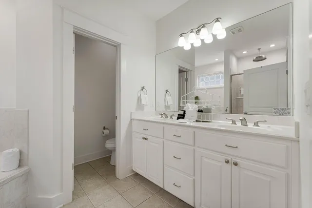 a bathroom with a double vanity sink and a mirror