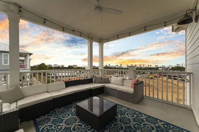 a view of a balcony with couches and city view