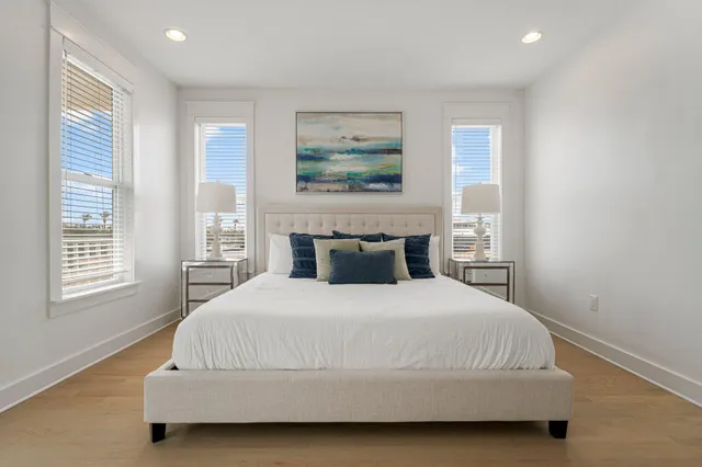 a bedroom with a bed and a painting on the wall