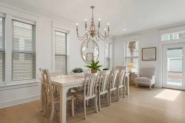 a view of a dining room with furniture and chandelier