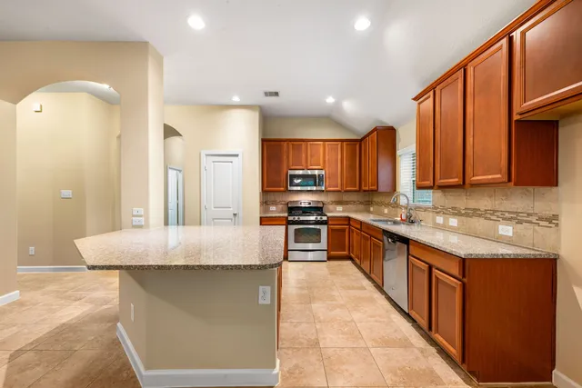 a bathroom with a tub a sink and a mirror