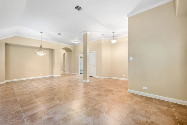 a large kitchen with stainless steel appliances granite countertop a large counter top a stove a sink a refrigerator and a cabinets