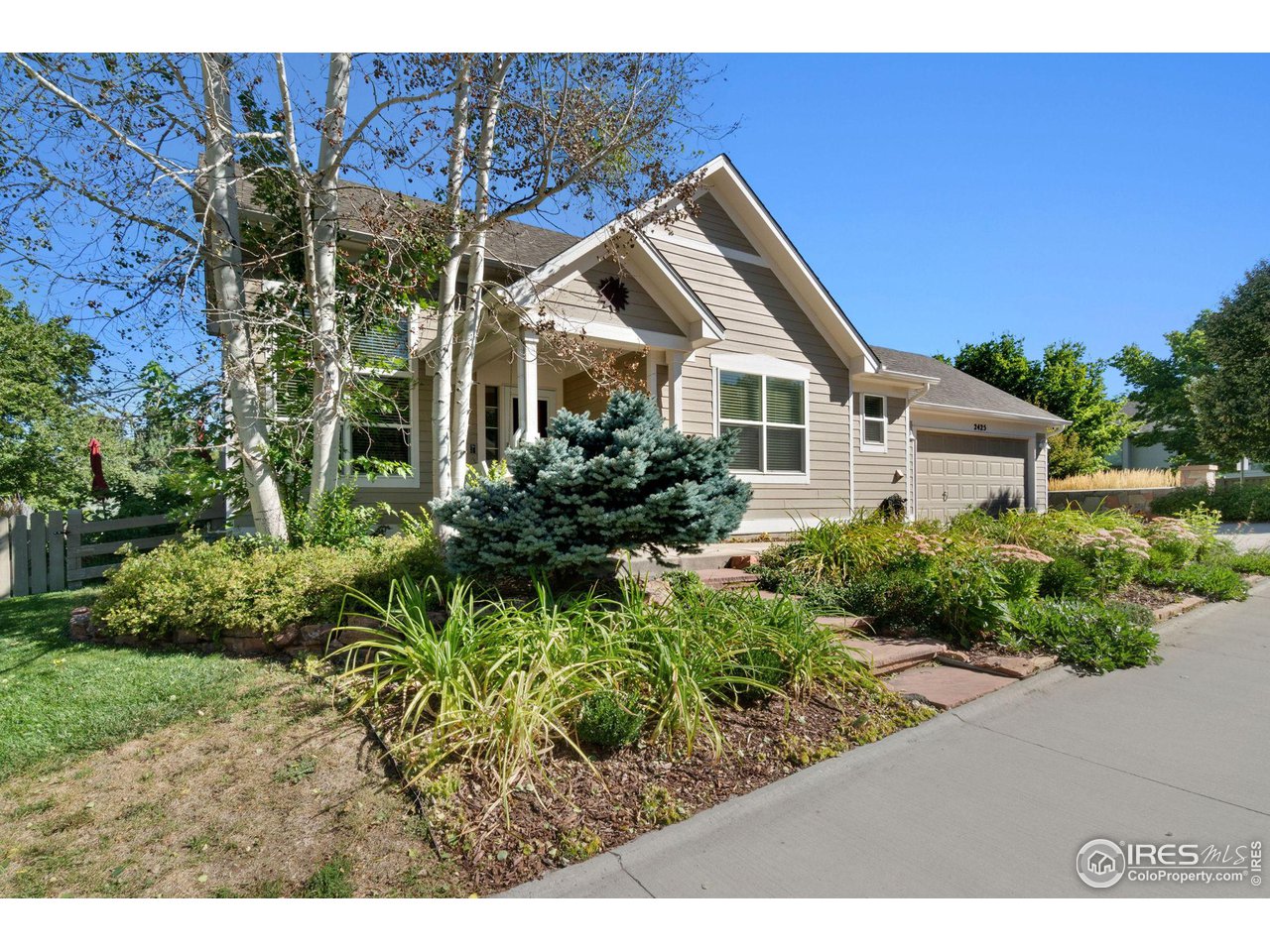 a view of a house with a yard and potted plants