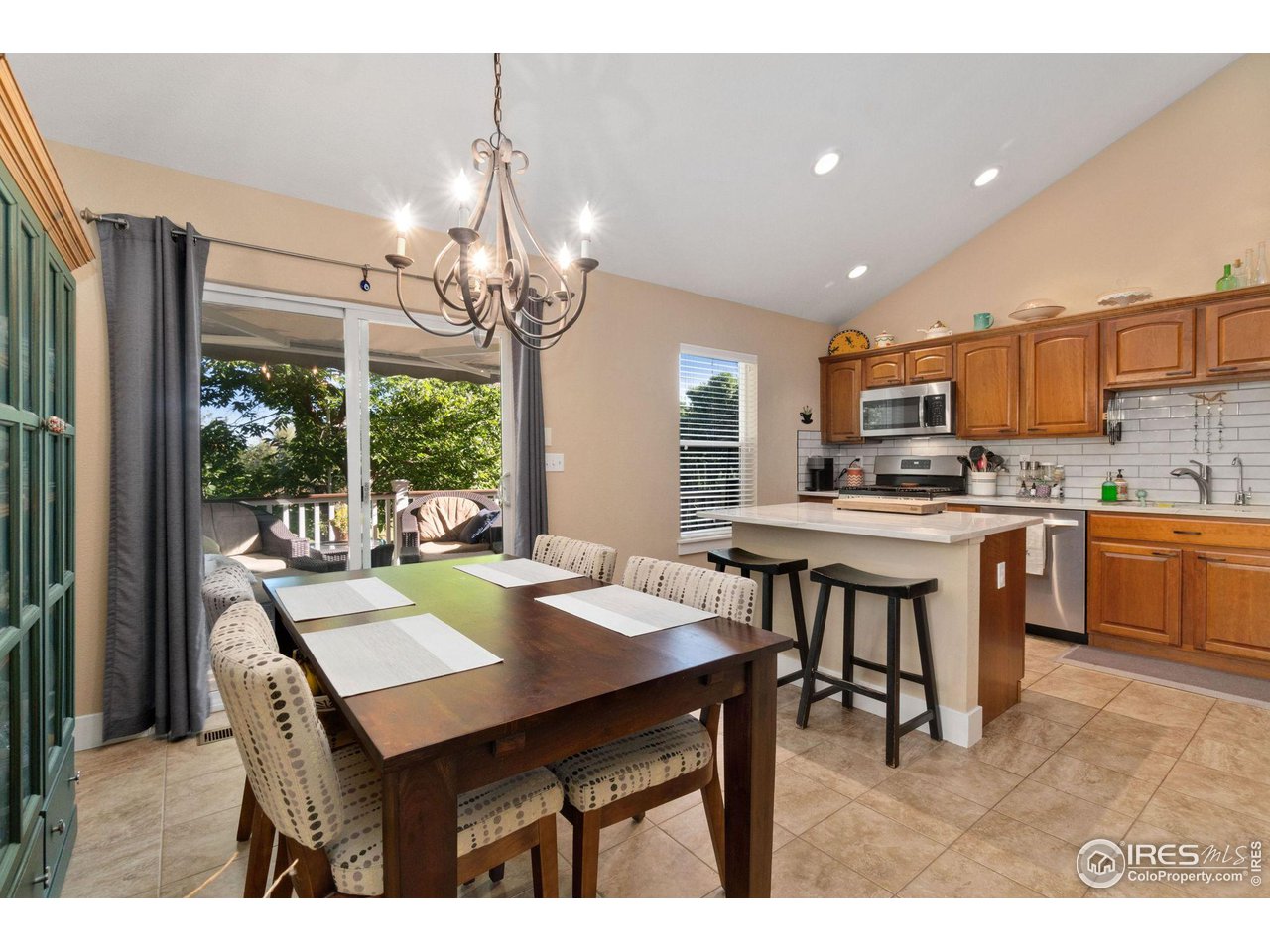 2425 Windrow Lane Lafayette, CO 80026 - Photo 11 of 35 a open dining room with stainless steel appliances kitchen island granite countertop a dining table chairs and a kitchen view