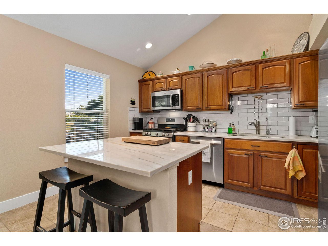2425 Windrow Lane Lafayette, CO 80026 - Photo 12 of 35 a kitchen with stainless steel appliances granite countertop a stove top oven a sink dishwasher and cabinets