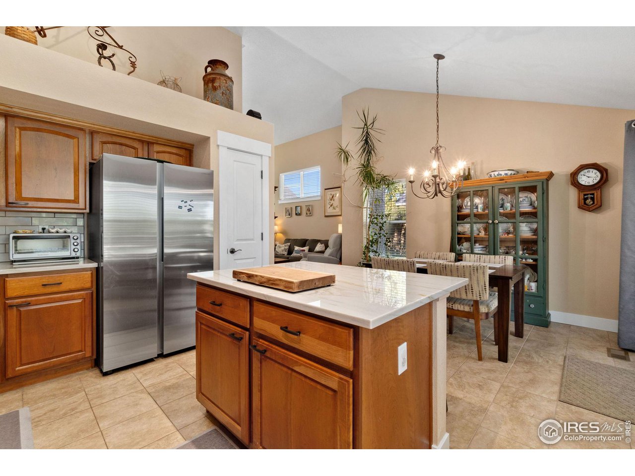 2425 Windrow Lane Lafayette, CO 80026 - Photo 13 of 35 a kitchen with stainless steel appliances kitchen island a chandelier and refrigerator