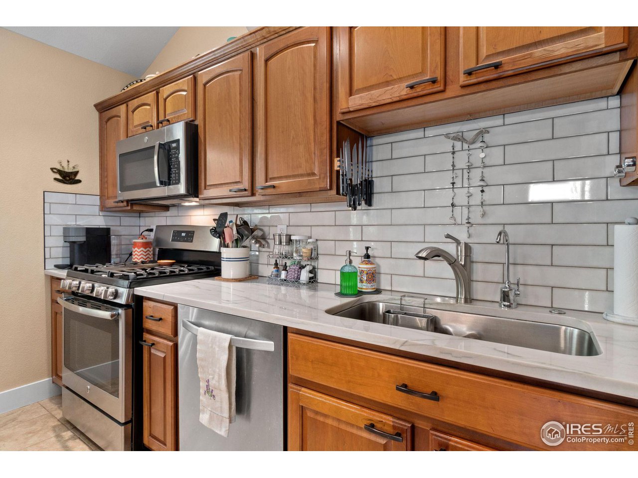 2425 Windrow Lane Lafayette, CO 80026 - Photo 15 of 35 a kitchen with stainless steel appliances granite countertop a sink stove and microwave