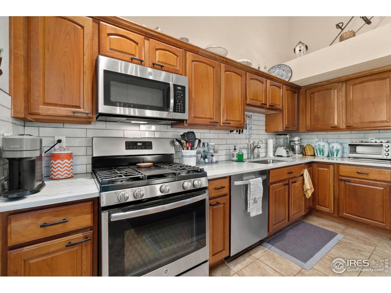 2425 Windrow Lane Lafayette, CO 80026 - Photo 16 of 35 a kitchen with stainless steel appliances granite countertop a stove microwave and cabinets