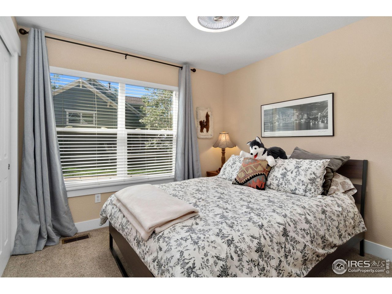 2425 Windrow Lane Lafayette, CO 80026 - Photo 18 of 35 a bed sitting in a bedroom next to a window