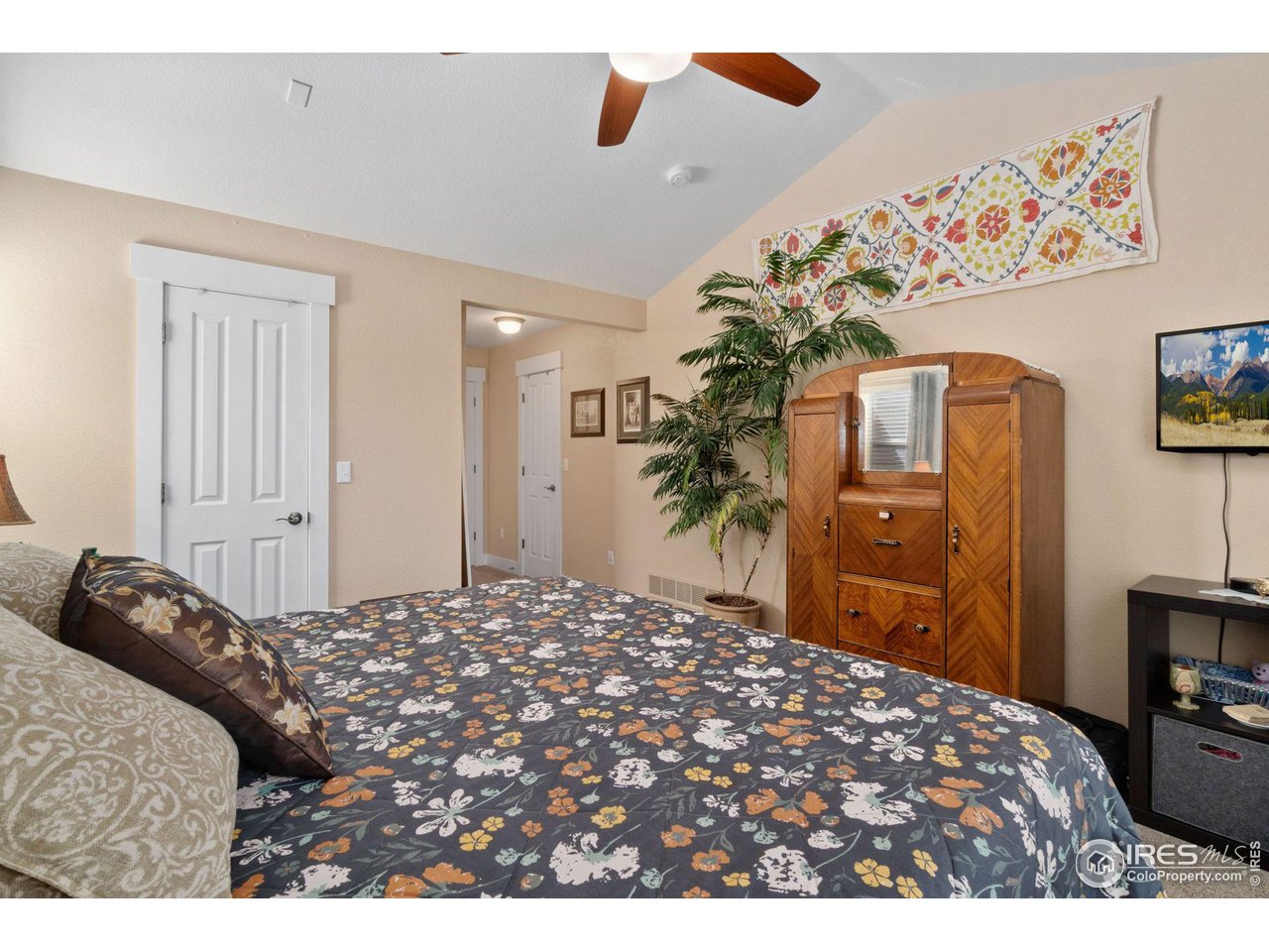 2425 Windrow Lane Lafayette, CO 80026 - Photo 22 of 35 a bedroom with a bed and a television