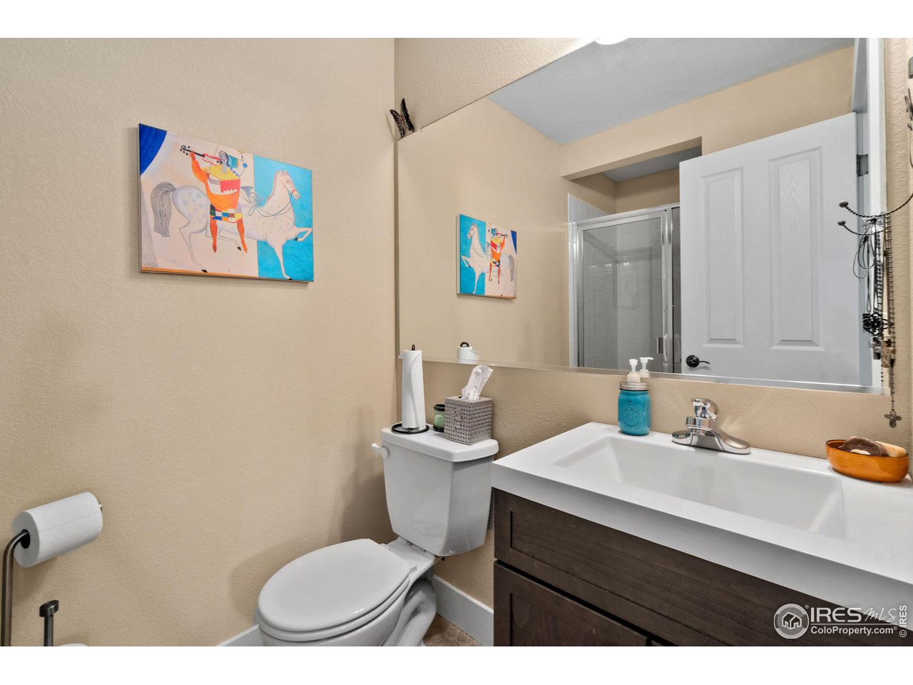 2425 Windrow Lane Lafayette, CO 80026 - Photo 24 of 35 a bathroom with a sink a toilet a mirror and vanity