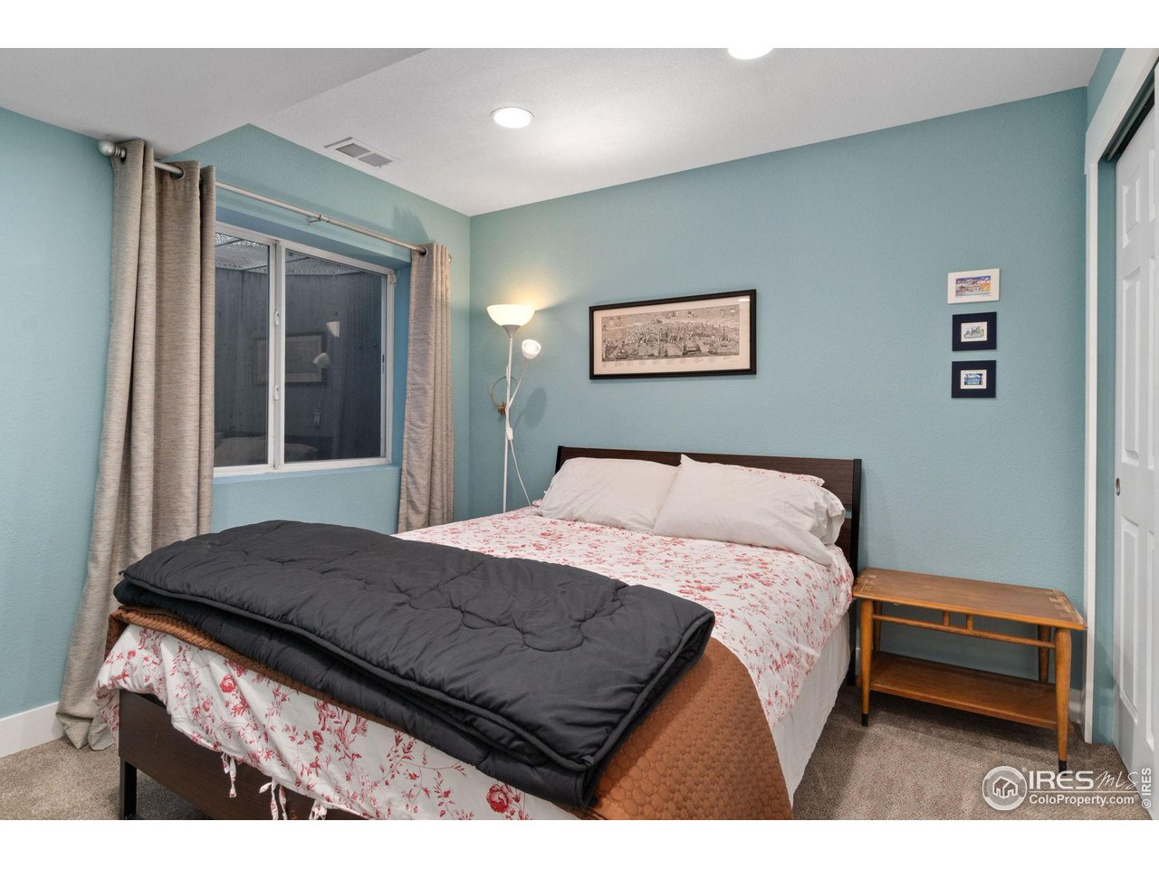 2425 Windrow Lane Lafayette, CO 80026 - Photo 30 of 35 a bedroom with a bed and a painting on the wall