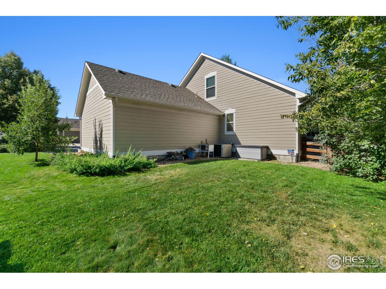 2425 Windrow Lane Lafayette, CO 80026 - Photo 34 of 35 a backyard of a house with plants and large tree