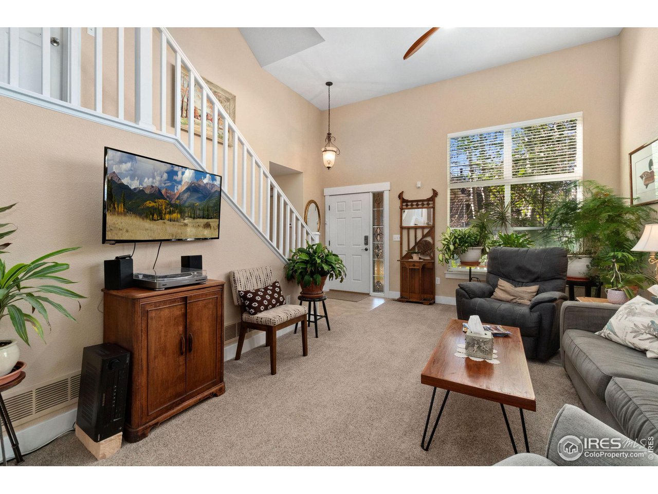 2425 Windrow Lane Lafayette, CO 80026 - Photo 8 of 35 a living room with furniture a window and a flat screen tv