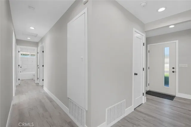 a view of a hallway with wooden floor