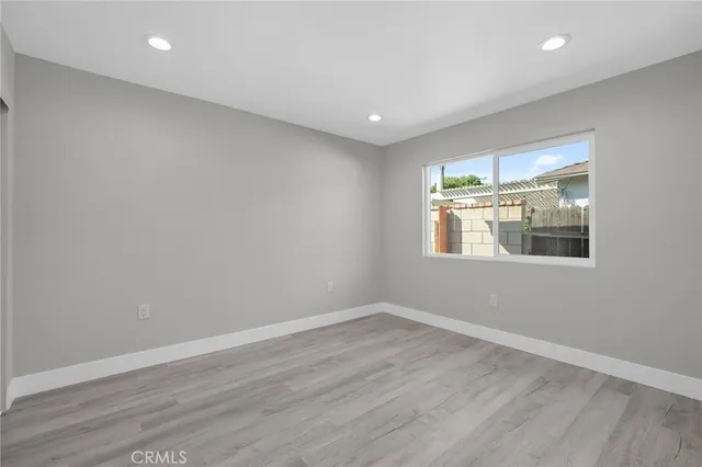 a room with wooden floor and window