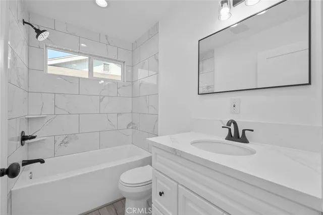 a bathroom with a sink a toilet and bathtub