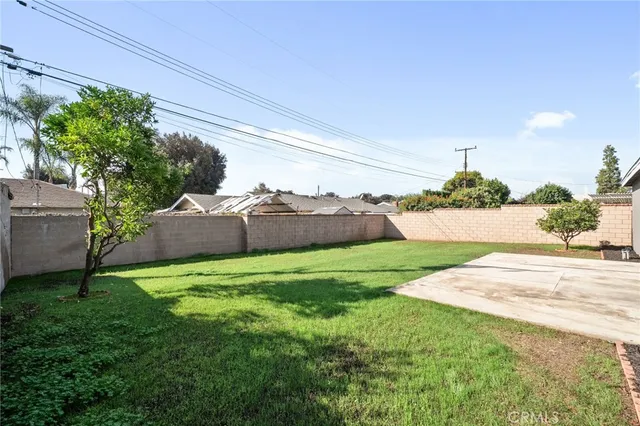 a view of a backyard with plants and a garden