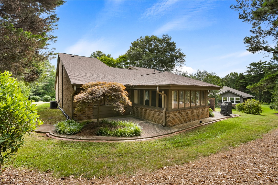 34 Hickory Way Clemson, SC 29631 - Photo 36 of 39 A classic brick exterior with a sun-drenched sunroom awaits outdoor gatherings on the adjoining patio.