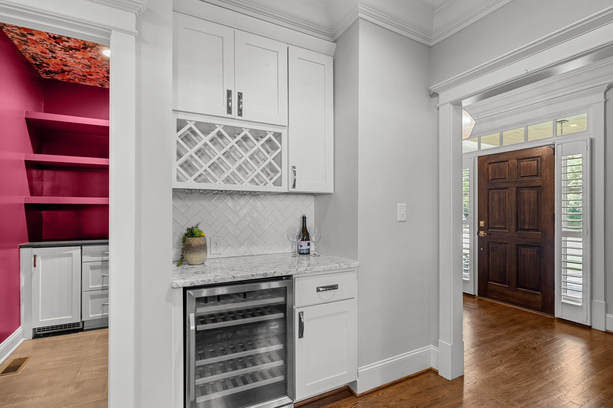 2116 Cowper Drive Raleigh, NC 27608 - Photo 18 of 65 Built in shelves, wine rack and wine fridge compliment this pass-through bar conveniently located right off of the dining room. Wine Bar
