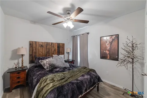 a bedroom with a large bed and a chandelier