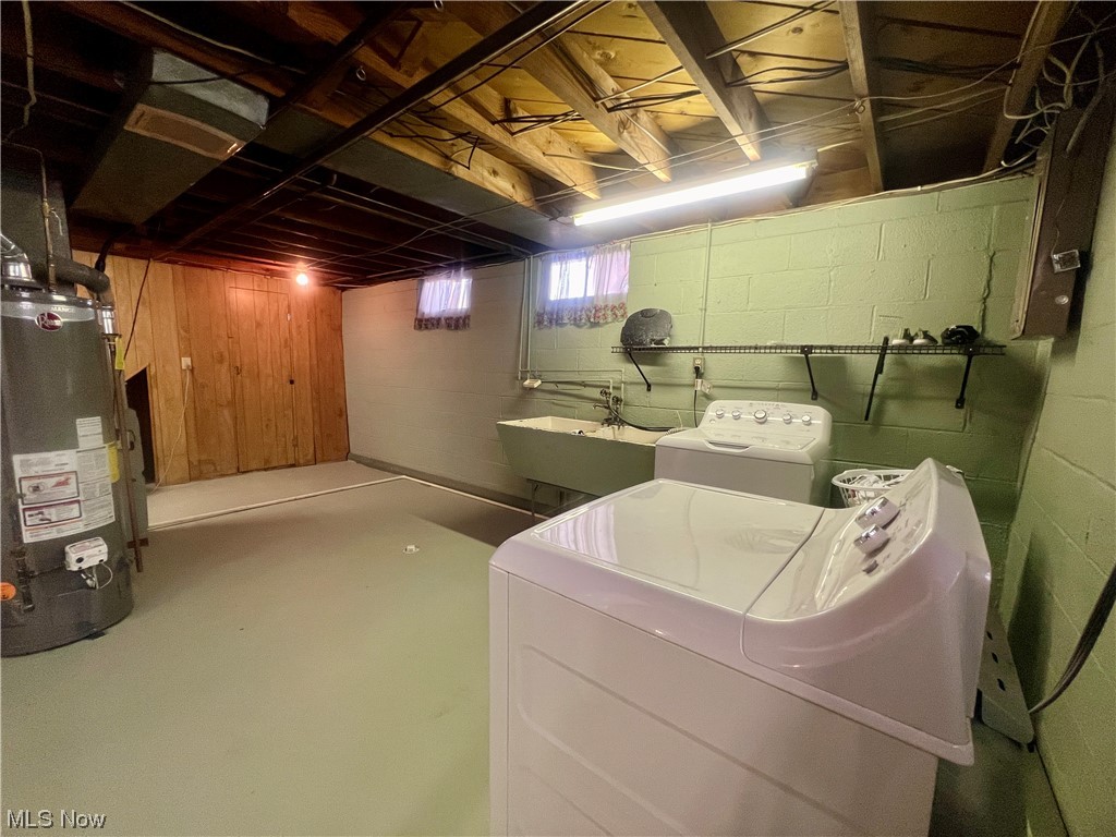 229 Hilliard Road Elyria, OH 44035 - Photo 21 of 28 Laundry area featuring gas water heater, independent washer and dryer, and sink