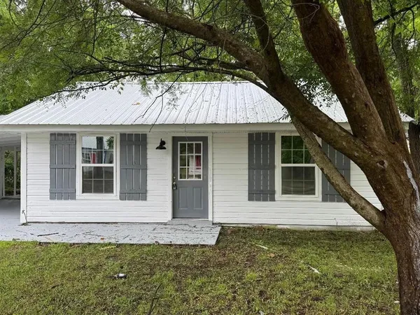 a house with a tree in front of it