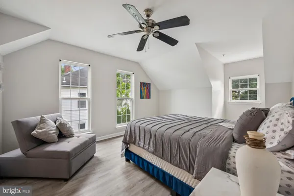 a bedroom with a bed couch and window