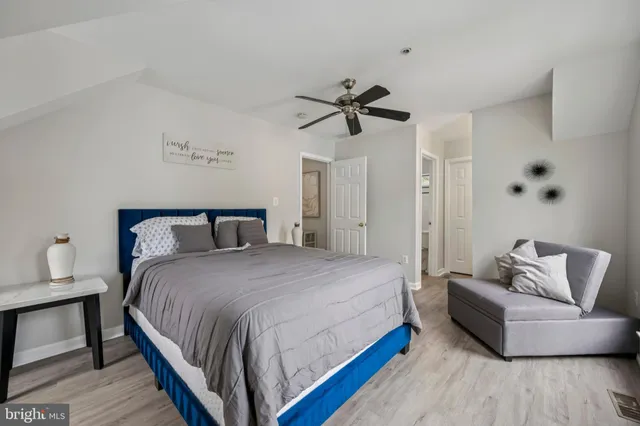 a bedroom with a bed couch and a window