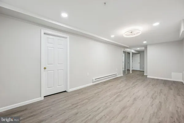 a view of an empty room with wooden floor