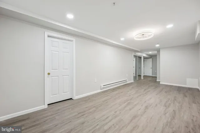 a view of an empty room with wooden floor