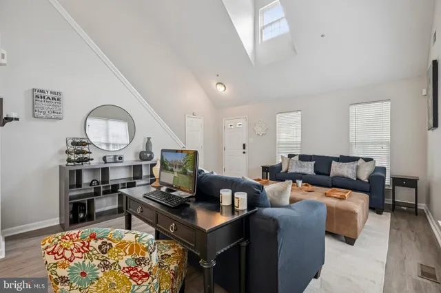 a living room with furniture a rug and a window