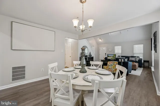a view of a dining room with furniture wooden floor and chandelier