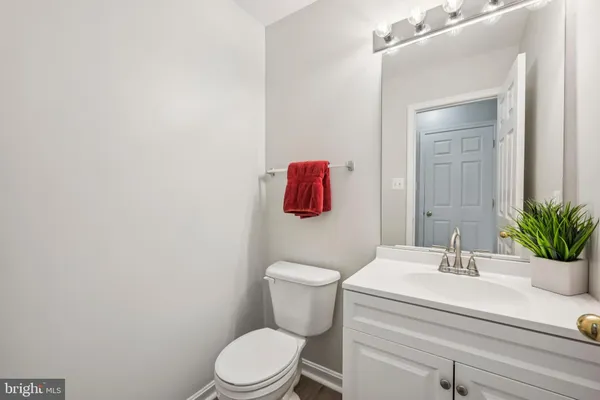 a bathroom with a sink a toilet and mirror