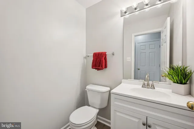 a bathroom with a sink a toilet and mirror