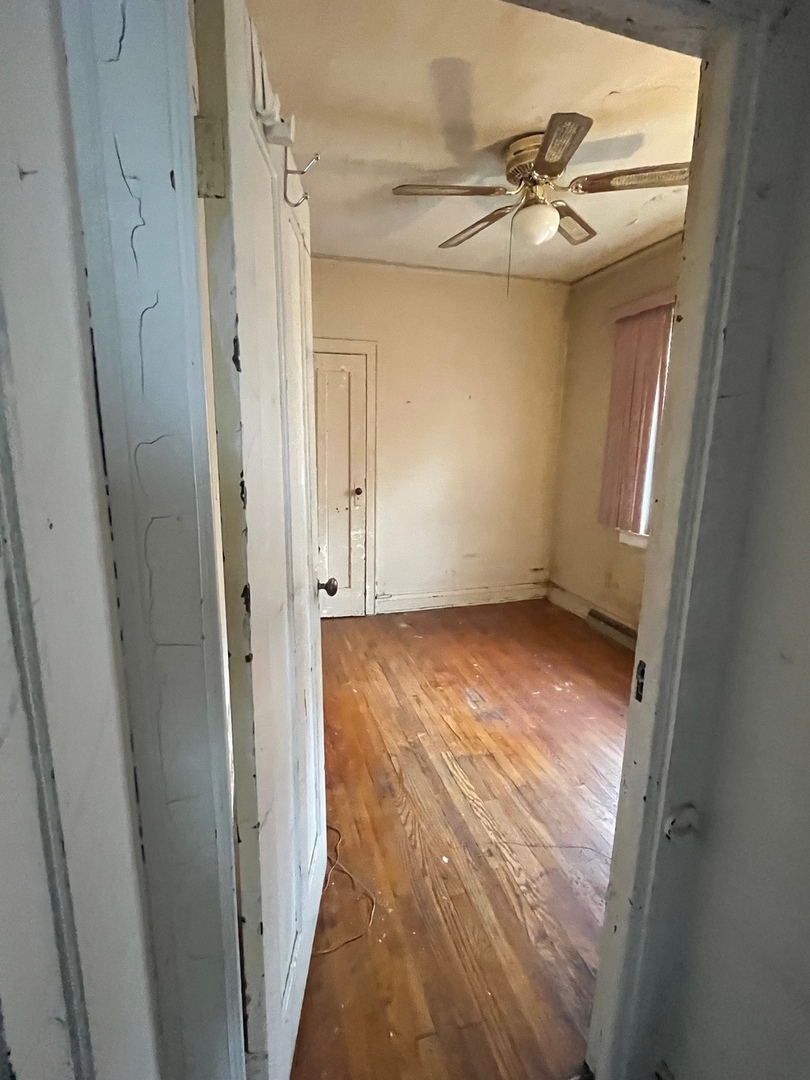 Undisclosed Address Chicago, IL 60628 - Photo 3 of 9 a view of a room with wooden floor and white walls