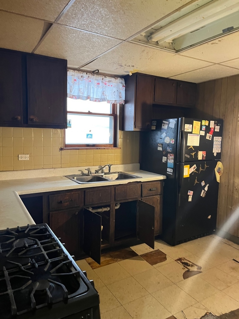Undisclosed Address Chicago, IL 60628 - Photo 5 of 9 a kitchen with a sink stove and cabinets