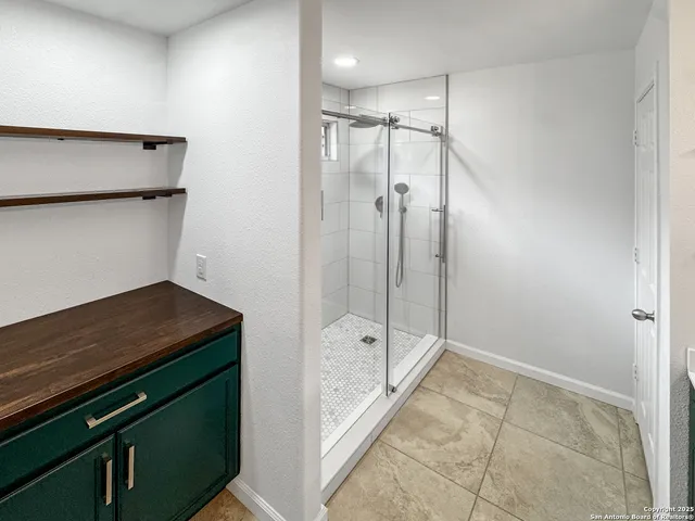 a bathroom with a shower and a sink