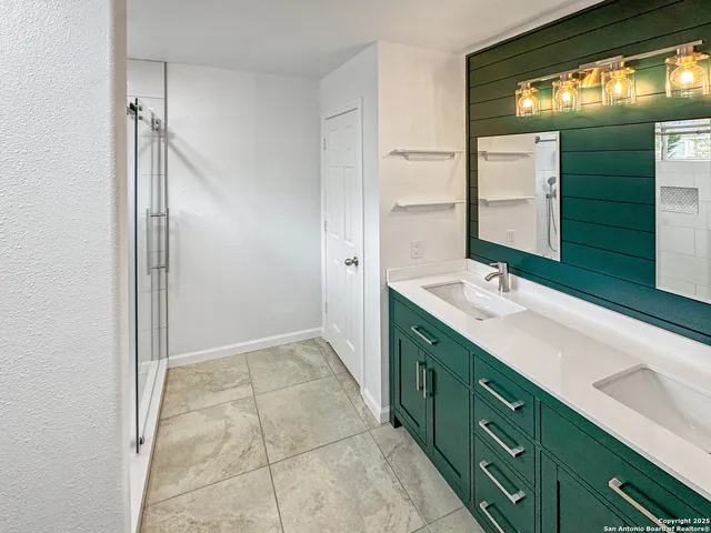 a bathroom with a double vanity sink and mirror