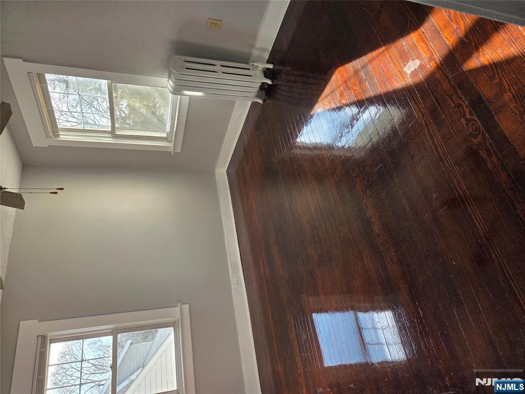 250 Ridgefield Avenue, Unit 2 Bogota, NJ 07603 - Photo 3 of 9 an empty room with wooden floor and windows