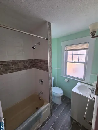 a bathroom with a sink toilet a shower and bathtub