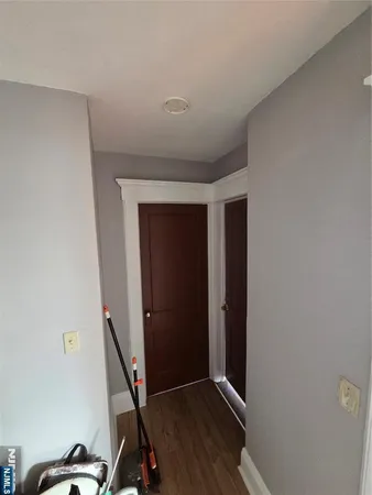 a view of a room with wooden floor