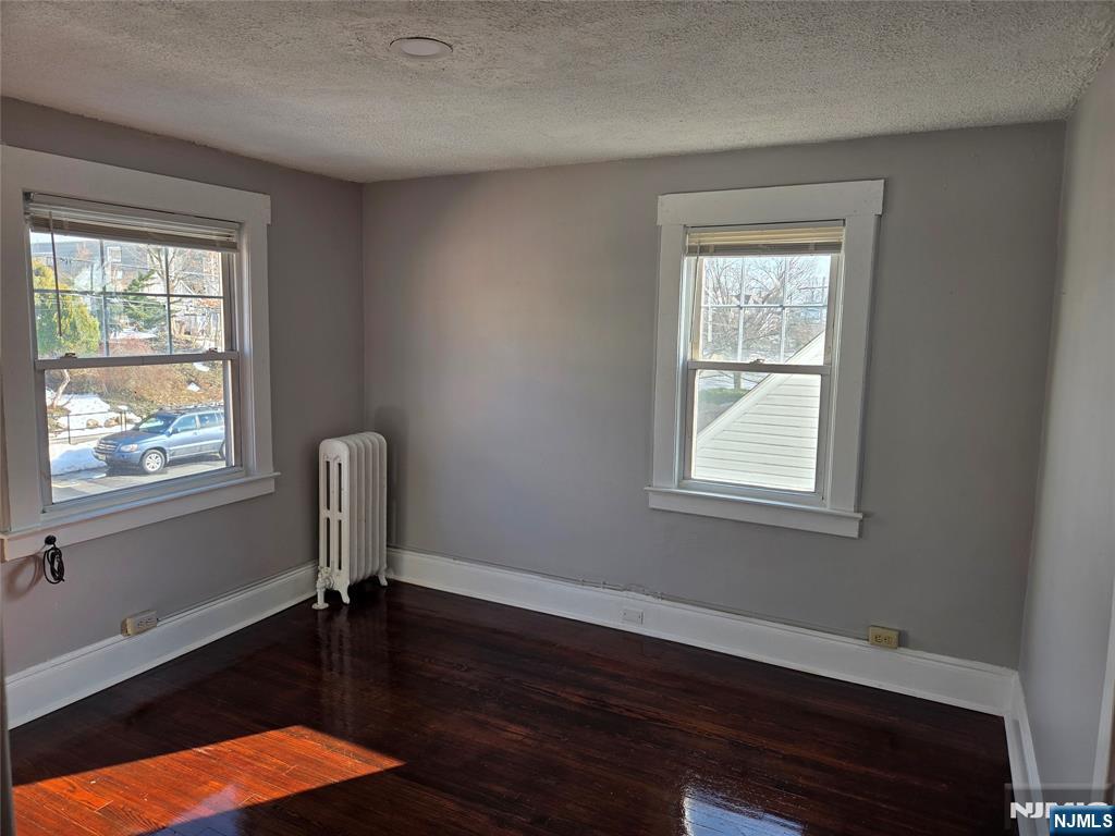 250 Ridgefield Avenue, Unit 2 Bogota, NJ 07603 - Photo 7 of 9 a view of empty room with wooden floor and fan