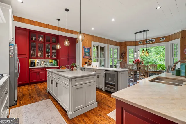 a bedroom with a bed a couch and a large window
