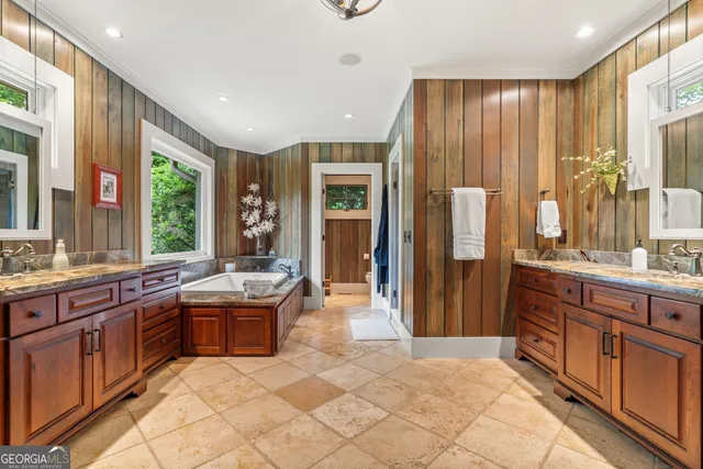 a bathroom with a toilet a sink a mirror and a shower