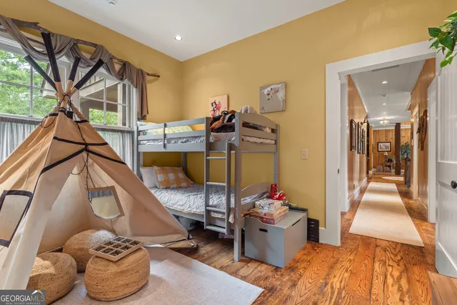 an aerial view of a house with a swimming pool and garden