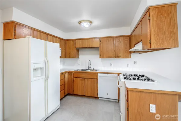 a kitchen with a sink stove and cabinets