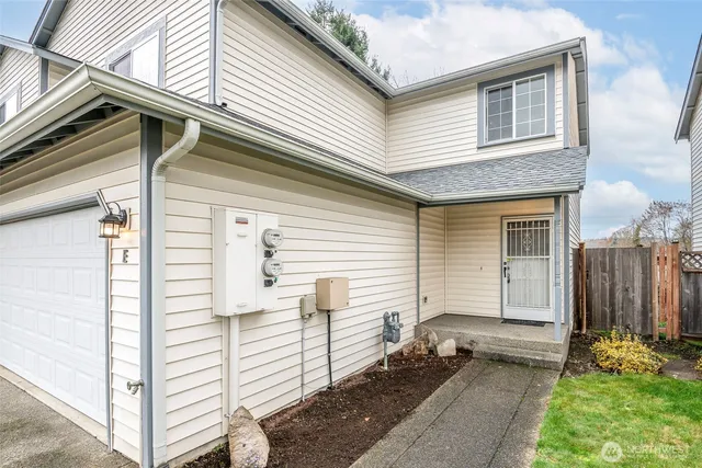 a view of a white house with a white door and stairs